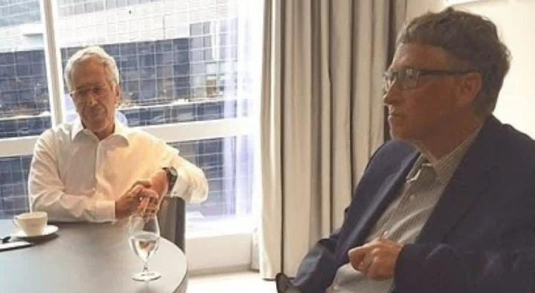 Bill Gates and Jeffrey Epstein sitting together at a formal event,